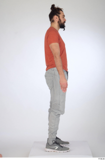 Turgen casual dressed grey sneakers grey trousers orange t-shirt standing…